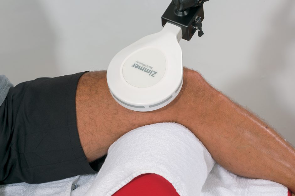 Person receiving a Zermeo massage device on their arm against a neutral background